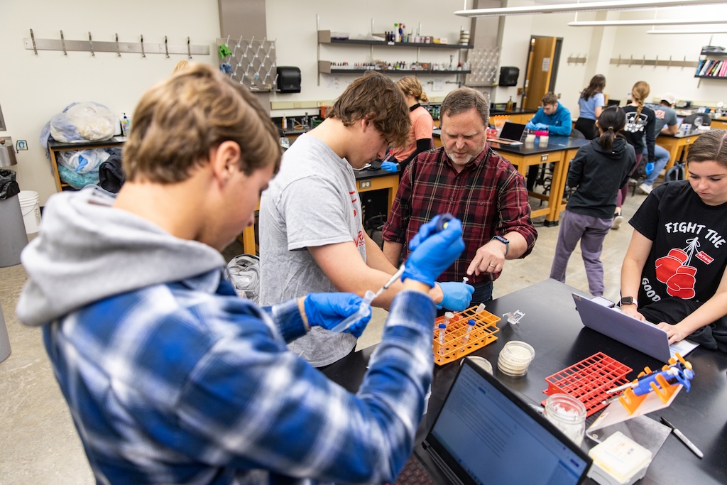 Students using pipettes in a microbiology class