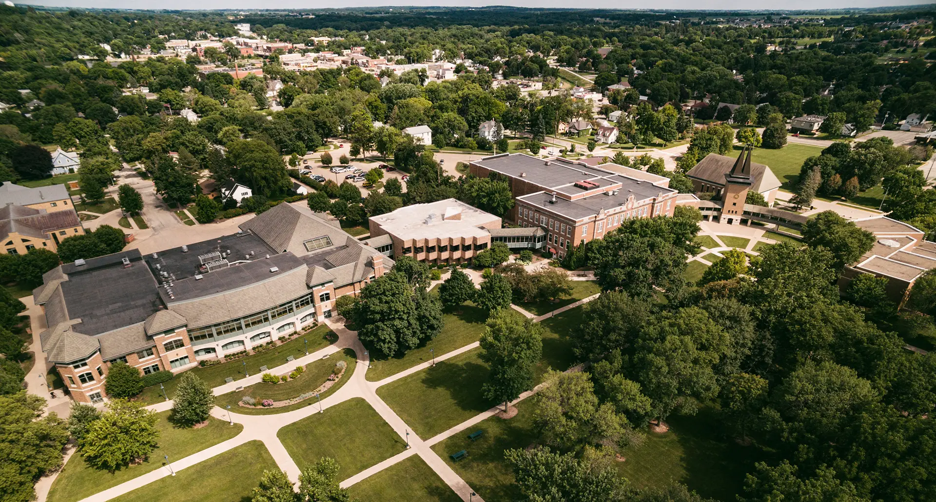 Aerial shot of campus looking to the east - Saemann Student Center and Whitehouse Business Center visible through the trees