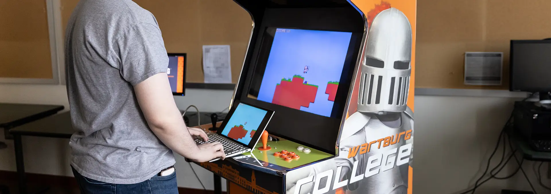 Computer science student demonstrating computer game he designed